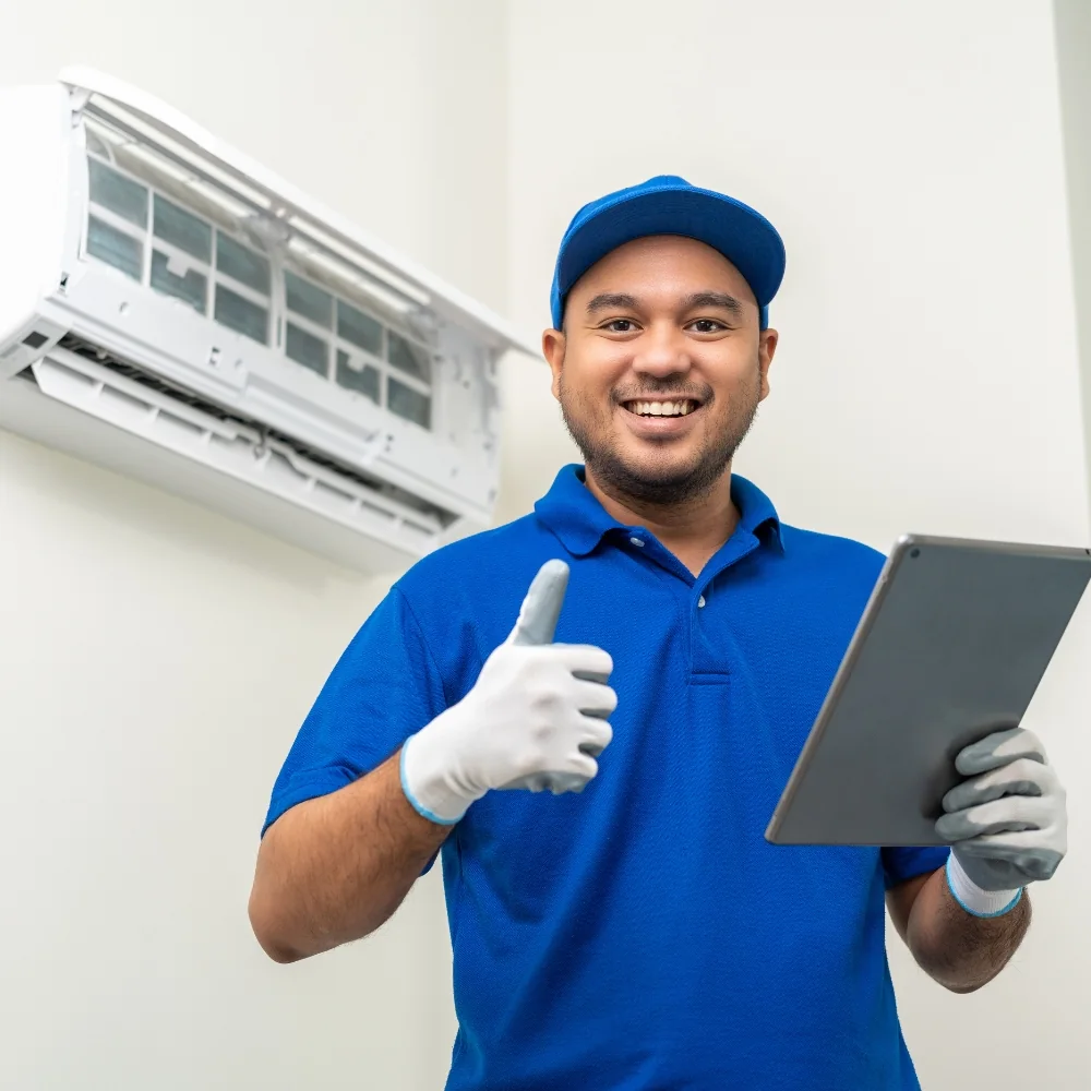 Technician after servicing a split AC
