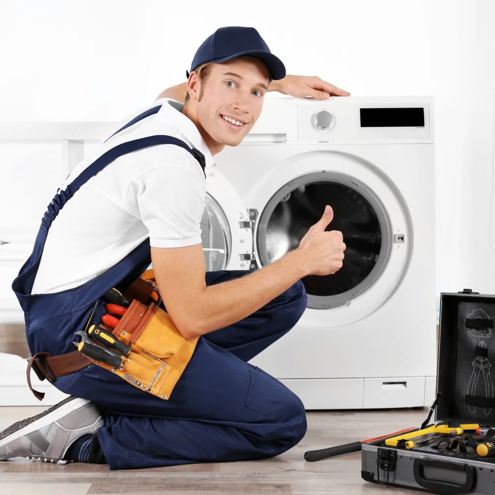 Technician repairing a front load washing machine